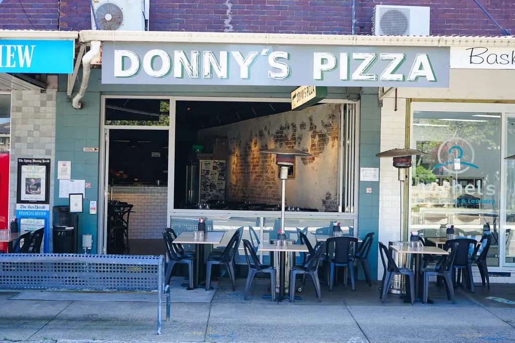 The Donny's Pizza shopfront on Great North Rd, Abbotsford, with tables on the footpath