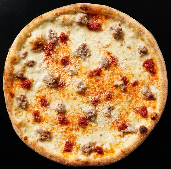 Hot Honey pizza from above: white base, sausage, nduja and grated ricotta