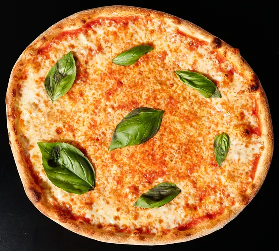 Margherita pizza from above with basil leaves